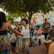 Atividade cultural comunitária em espaço público de Três Lagoas, com artistas e moradores reunidos